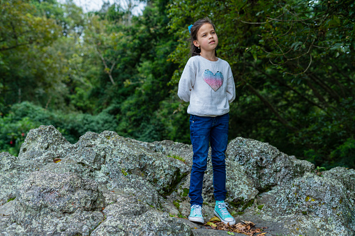 7 year old latina girl dressed comfortably is enjoying a beautiful trip in villa de leyda in boyaca photographed in ancient and touristic places