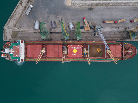 Container ship in loading/unloading at port.