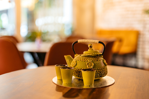Close-up of a teapot shaped cake on the table in a café.