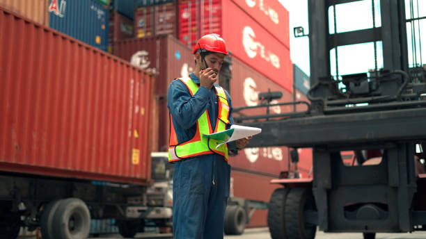 istock staff survey load container for shipping plan in Logistic container area company. 1445776715