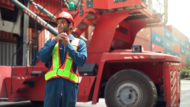istock Maintenance engineer communicate to manage container and truck in container logistic area. 1445776724