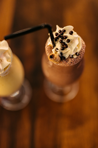Close-up of a chocolate milkshake on the table in a café.