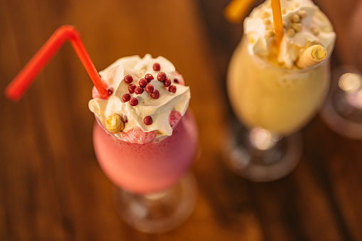 Close-up of a strawberry milkshake on the table in a café.