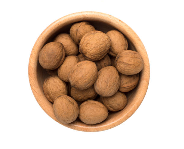 istock Walnuts with leaves isolated on white, top view 1445777285