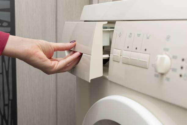 istock man opens the tray in the washing machine 1445780612