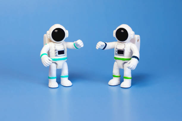 istock Plastic figurines of an astronauts in a spacesuit on a blue background 1445782442