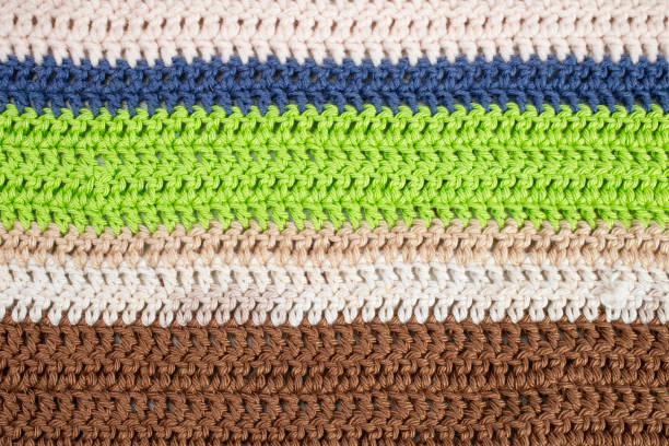 horizontal colored crochet lines pattern, beige, blue, green and brown colors, horizontal rows  close up background