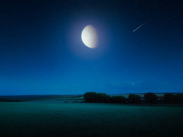 istock Big bright moon in the night sky over the fields. 1445783101