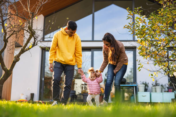 istock Two Affectionate Parents Walking Outdoors With Their Cute Baby Daughter 1445783234