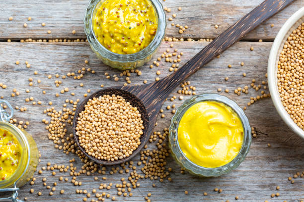 istock Different types of mustard and mustard seeds on a rustic wooden board 1445783761