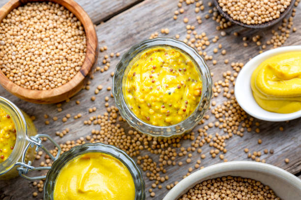 istock Different types of mustard and mustard seeds on a rustic wooden board 1445783803