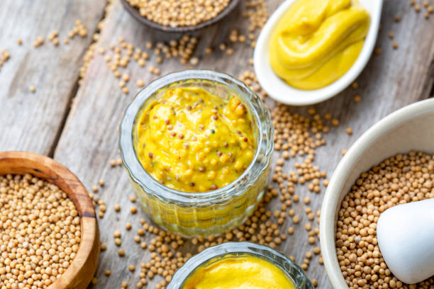 istock Different types of mustard and mustard seeds on a rustic wooden board 1445783879