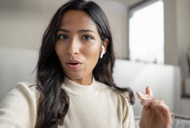 Female Influencer Vlogging Online With Smartphone From Home stock photo