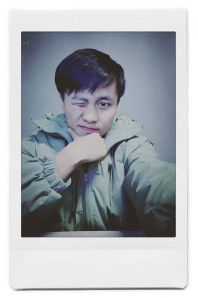 istock A man is taking a selfie with a Polaroid 1445790698