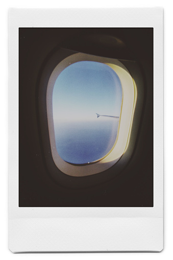 Polaroid took pictures of the clouds outside the plane window