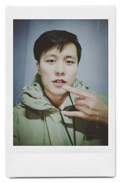 istock A man is taking a selfie with a Polaroid 1445790816