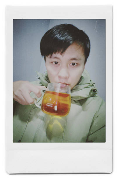 A man is taking a selfie with a Polaroid
