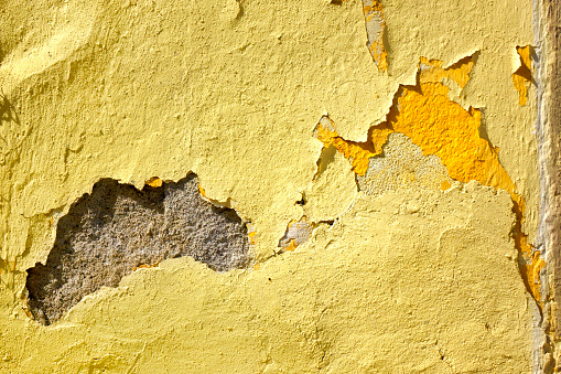 Close up abstract background image of peeled painted concrete wall texture