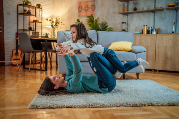 istock Mother and daughter playing together at home 1445792244
