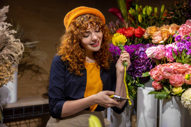 istock Pretty florist sorting the flowers and looking involved 1445793713