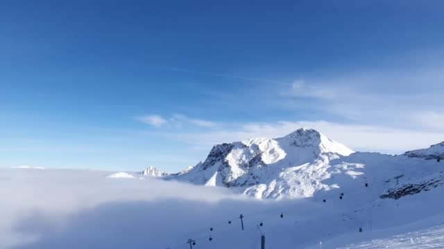Ski cable car ride above the clouds on a glacier