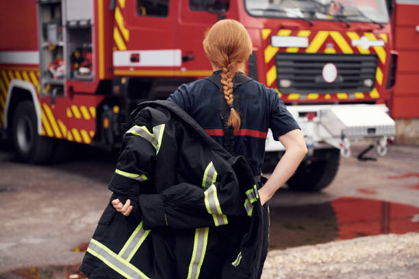 istock Rear view. Woman firefighter in uniform is at work in department 1445797097