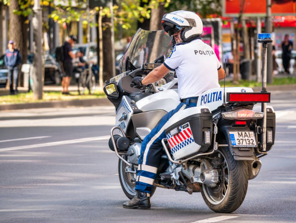 Traffic policeman on motorbike. Police officer control in the center of Bucharest Bucharest, Romania - June 2022: Traffic policeman on motorbike. Police officer control in the center of Bucharest riot police stock pictures, royalty-free photos & images