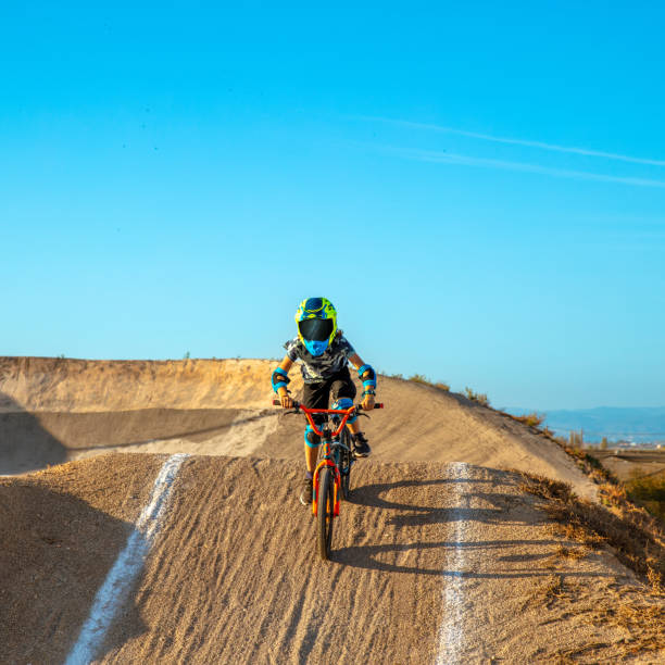 young boy riding with bmx young boy riding with bmx bmx racing stock pictures, royalty-free photos & images