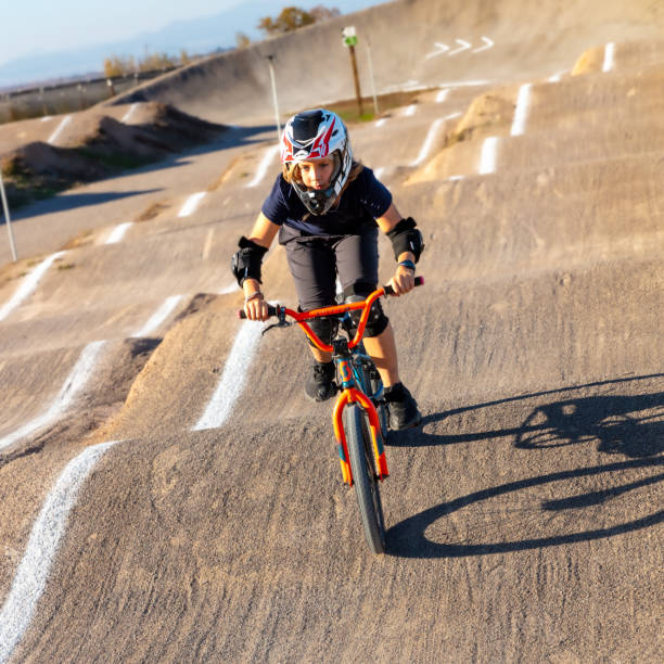 Tennager on bike- BMX rider competition Tennager on bike- BMX rider competition bmx racing stock pictures, royalty-free photos & images