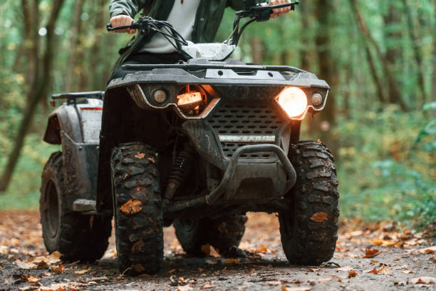 istock Front view. ATV driver is in the forest, having a ride at daytime 1445800574