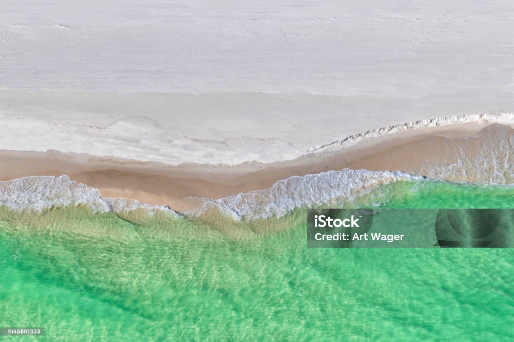 Beach Abstract From Above Waters breaking on a beach along the Gulf of Mexico on the panhandle of Florida, USA near Pensacola shot from directly above. Beach Stock Photo