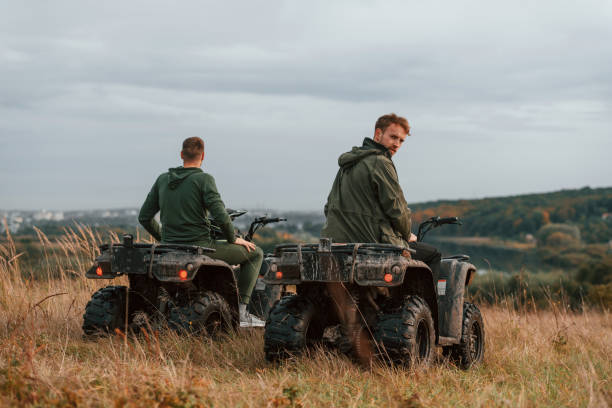 istock Majestic view. Two men are on the quad bikes outdoors on the field 1445801853