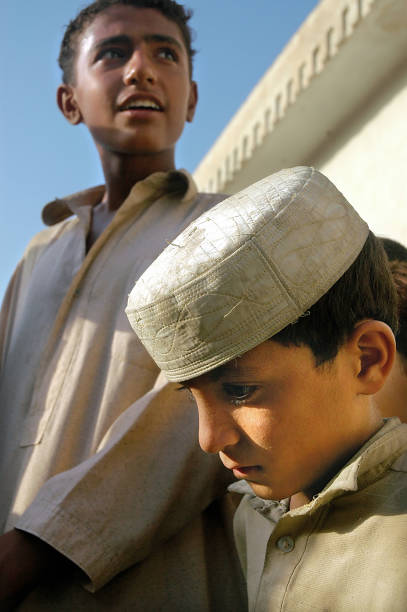 Jalalabad, Nangarhar Province / Afghanistan: Two Muslim boys in Jalalabad, Afghanistan. The two boys wear traditional clothes. Afghan boys, Muslim children, Jalalabad, Afghanistan.
