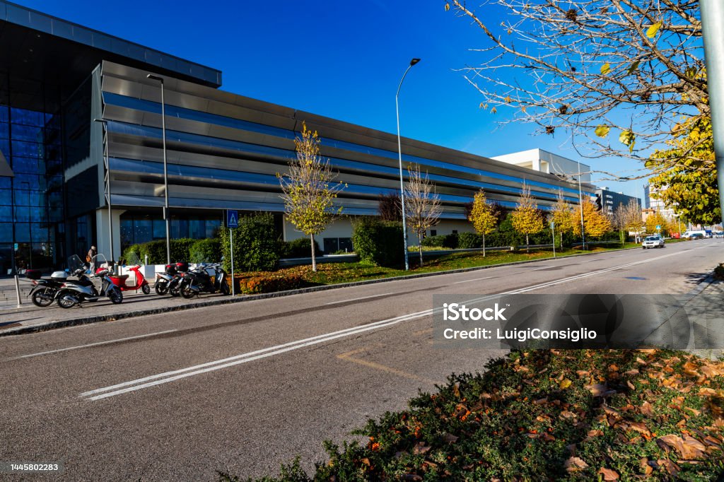 centro commerciale industrial area with shopping center green areas of hedges and trees along a road Architecture Stock Photo