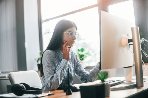 istock Young female designer is in the modern office working by computer 1445802305