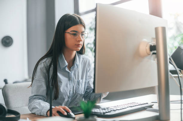istock Young female designer is in the modern office working by computer 1445802329