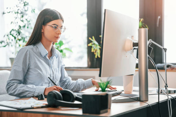 istock Young female retoucher working with computer and graphic tablet 1445802609