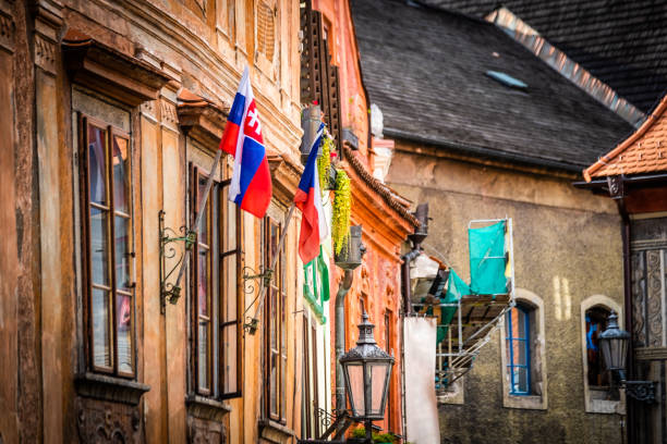 Side view of old building's architecture with nathional czech flags in Cesky Krumlov