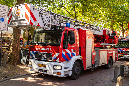 Amersfoort, Netherlands on August 12, 2021; Red Dutch fire trucks on a narrow street in the center of Amersfoort.