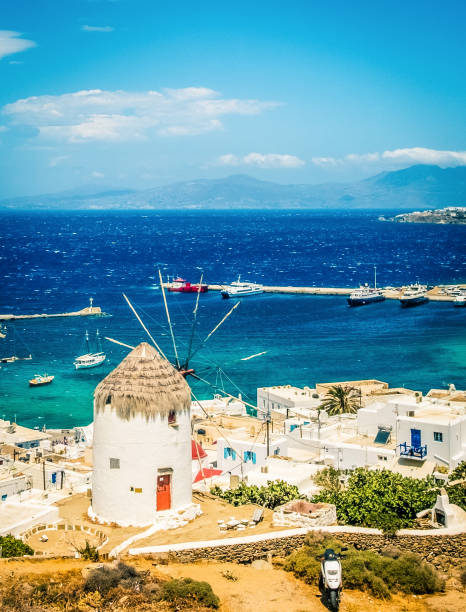 Picturesque view of Mykonos town and sea and windmill at sunny day