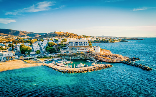 Beautiful aerial scenic view of Traditional Greek Mandrakia village by the sea with sirmate fishermen's houses on a sunny summer day in Milos town, Greek Islands, Cyclades, Greece.