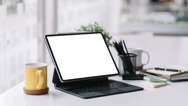 istock Tablet with keyboard blank white screen of placed on office table. Mock up. 1445806240