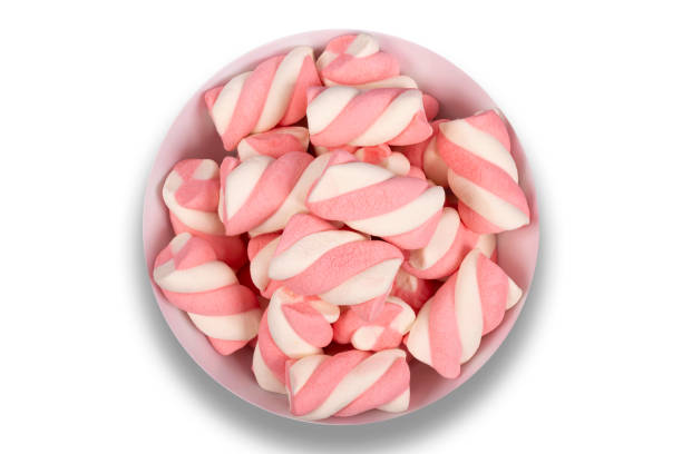 istock Bowl with pink candies on a white background. Top view. 1445808036