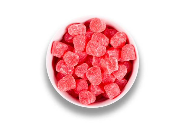 istock Red candy in bowl isolated on white background. Top view 1445808037