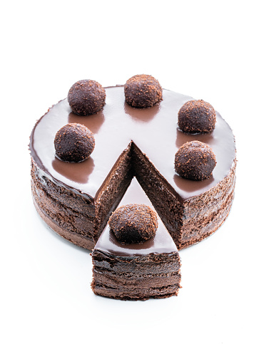Tasty  chocolate cake decorated with truffle isolated on white