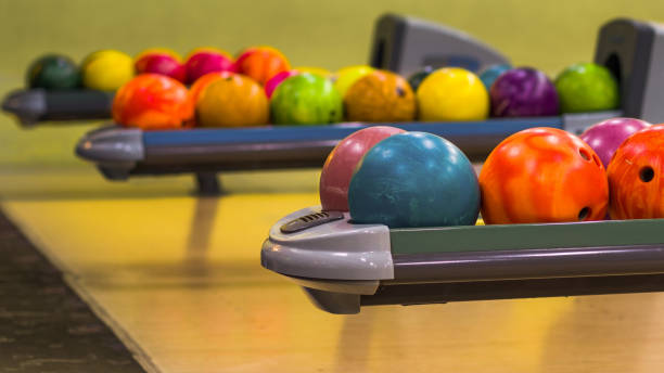 istock Bowling balls in the ball return machine. Selective focus on the front balls. Shallow depth of field. 1445808380