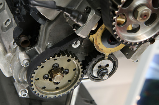 The detail of the cogwheels and belts of the timing of the petrol combustion engine. Used as teaching aids.