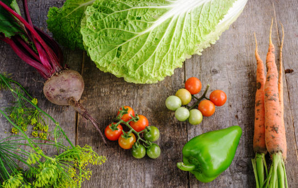 istock Fresh tomatoes, cabbage, radish, paper, garlyc and dill on wooden table, top view 1445810141
