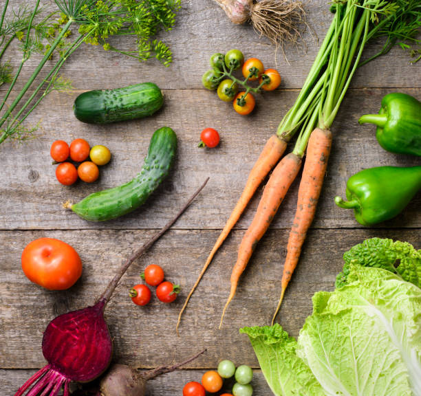 istock Fresh tomatoes, cabbage, radish, paper, garlyc and dill on wooden table, top view 1445810253