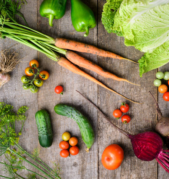 istock Fresh tomatoes, cabbage, radish, paper, garlyc and dill on wooden table, top view 1445810551